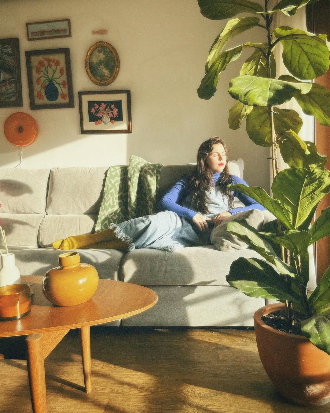 carlota flor sentada no sof&aacute; de sua casa a apanhar sol flor mesa casa vintage